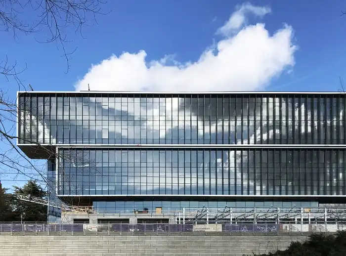 A office building with a semi-transparent vertical solar panel facad